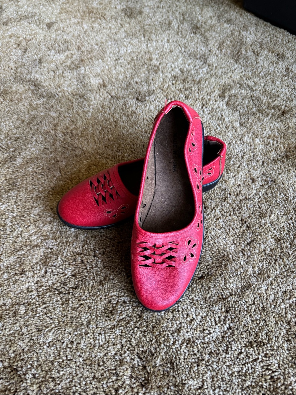Red leather loafers with butterfly cutouts; perfect condition, never worn
